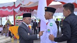 Pj. Bupati Aceh Jaya saat menyematkan pin secara simbolis kepada salah seorang calon anggota paskibraka Aceh Jaya 2024